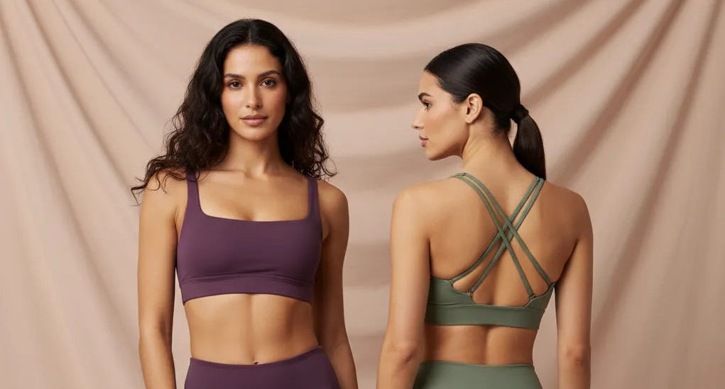 Two women wearing sports bras and leggings on a beige background
